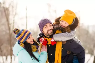 happy family outside in the snow
