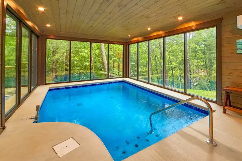 splashin around indoor pool in Gatlinburg with mountain view