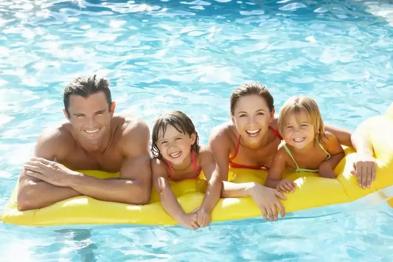 Happy family in water at Gatlinburg cabin with pool access