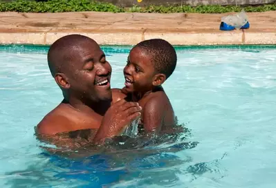 Dad and son playing in pool at Gatlinburg cabin