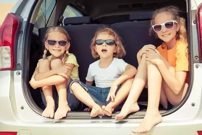Happy_kids_in_the_car_outside_of_their_2_bedroom_Gatlinburg_cabin