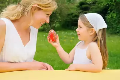 Daughter_shares_Easter_egg_with_her_mother_outside_of_their_three_bedroom_cabin_in_Gatlinburg