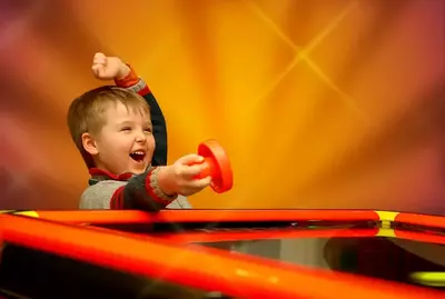 boy playing air hockey