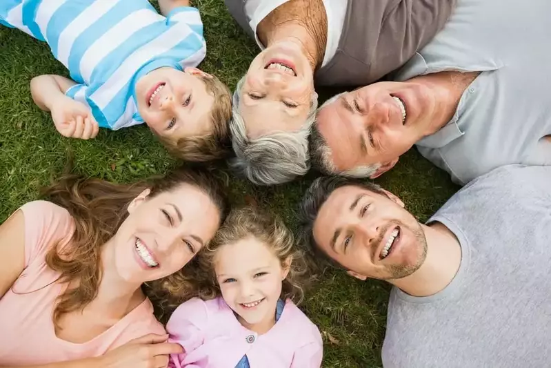 Family lying in a circle on the grass outside their Gatlinburg cabin