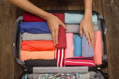 person packing their suitcase for a smoky mountain vacation