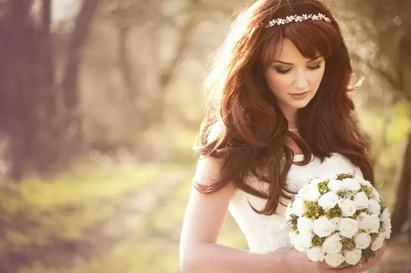 Beautiful bride looking at bouquet at Smoky Mountain wedding