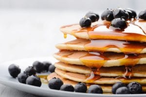 Blueberries on pancakes with syrup