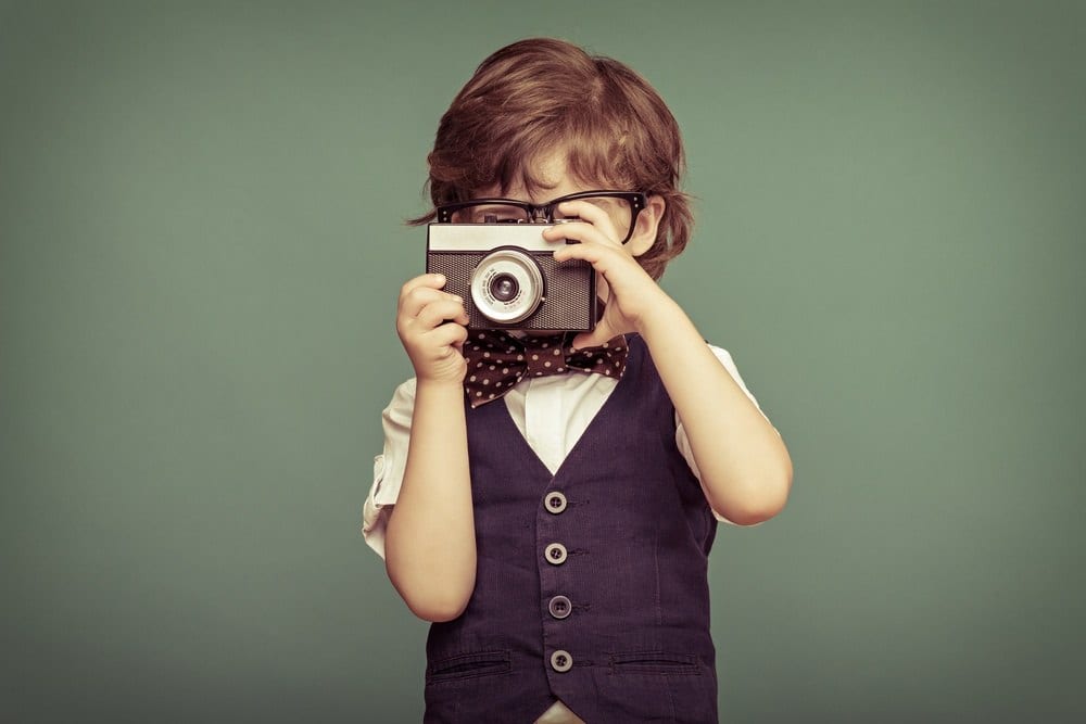 Young boy with retro camera