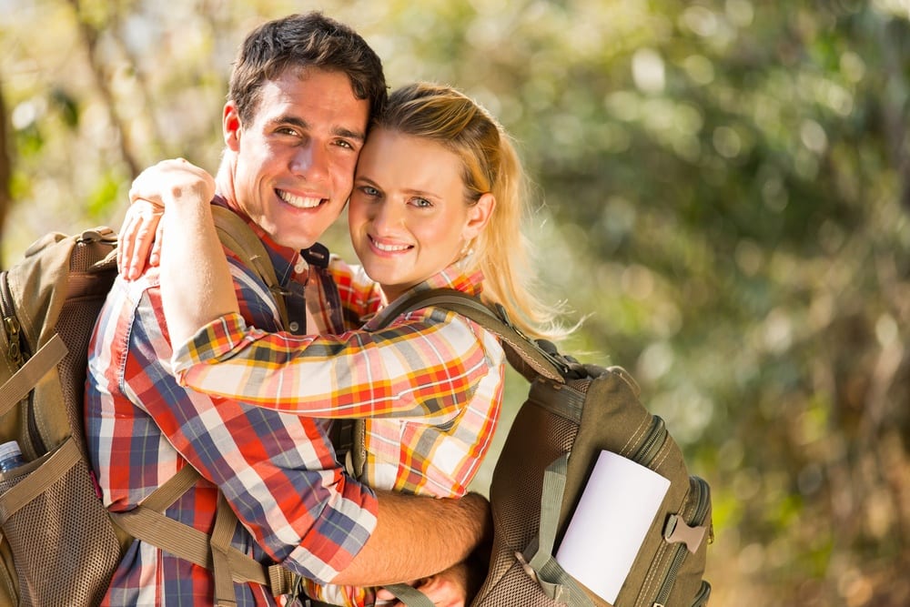 Happy young couple going on hike near their Smoky Mountain vacation rental