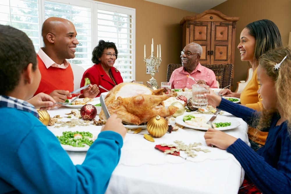 Happy family enjoying Thanksgiving dinner at a Smoky Mountain cabin