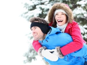 Man_giving_woman_a_piggyback_ride_during_a_winter_hike