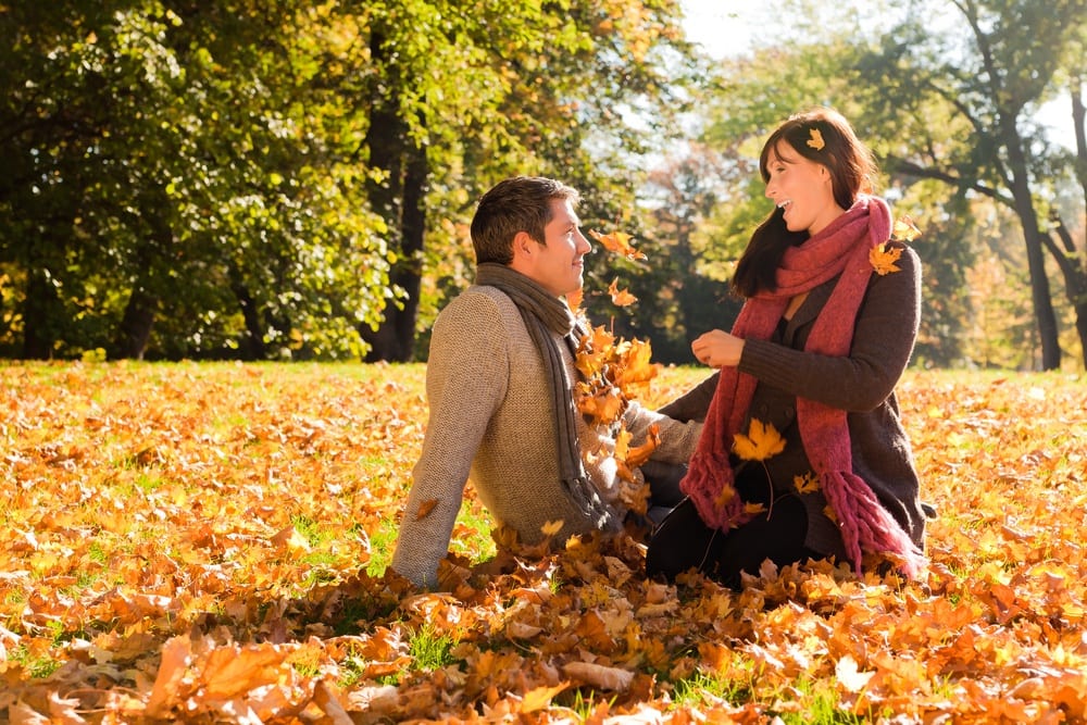 couple playing in the leaves