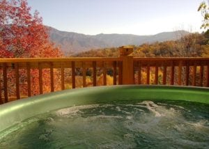 Hot tub on the deck of a Smoky Mountain cabin with an incredible view of the fall colors.