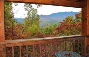 The deck of the Bear Naked cabin in Gatlinburg with beautiful views of the fall colors in the mountains.
