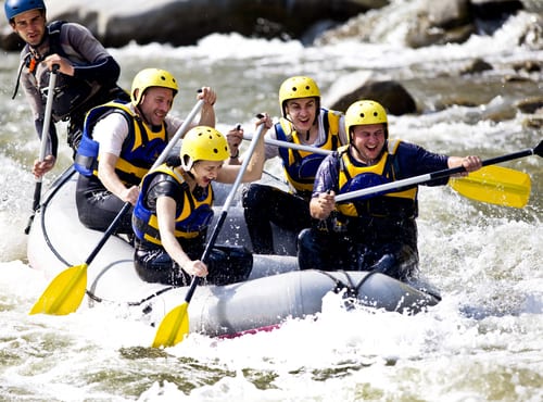 Group of people enjoying white water rafting in the Smoky Mountains
